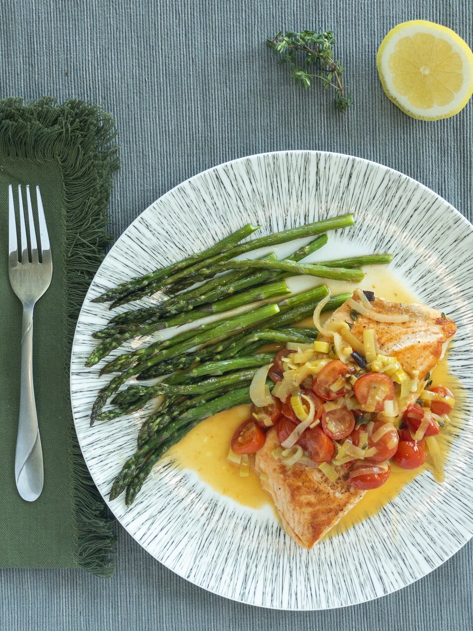 salmon with a tomato leek sauce over top