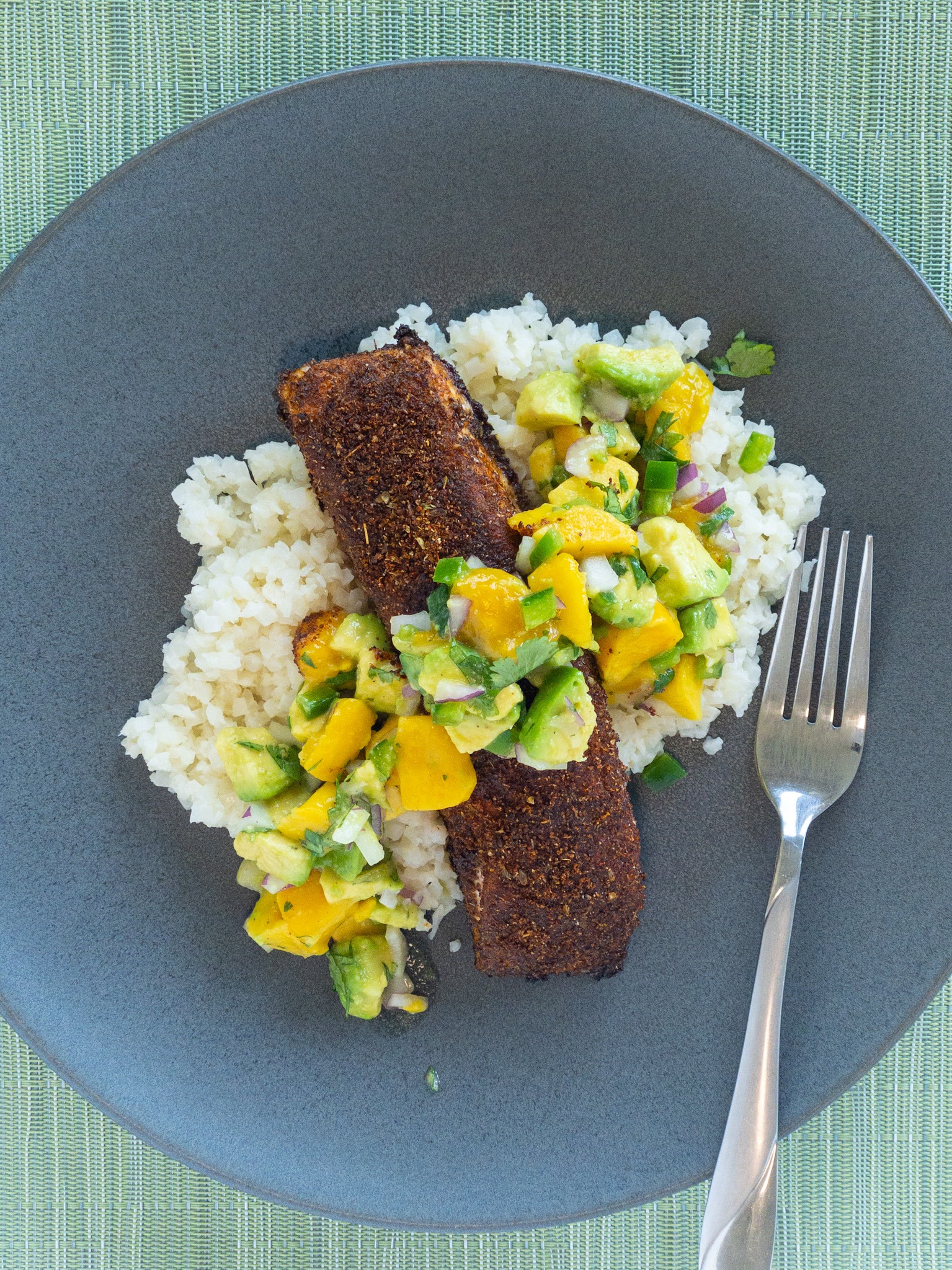 salmon over coconut rice and topped with mango salsa