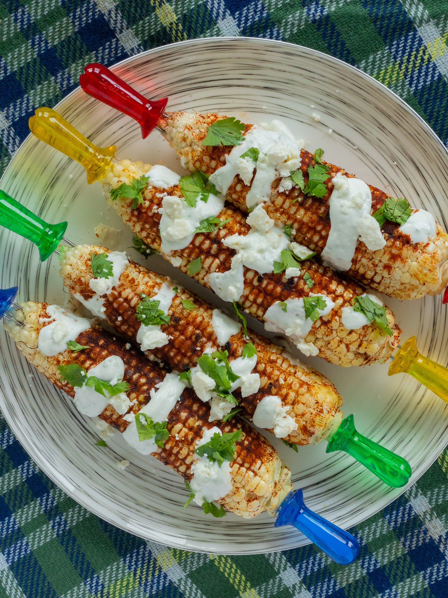 grilled corn with a lime crema drizzled on top