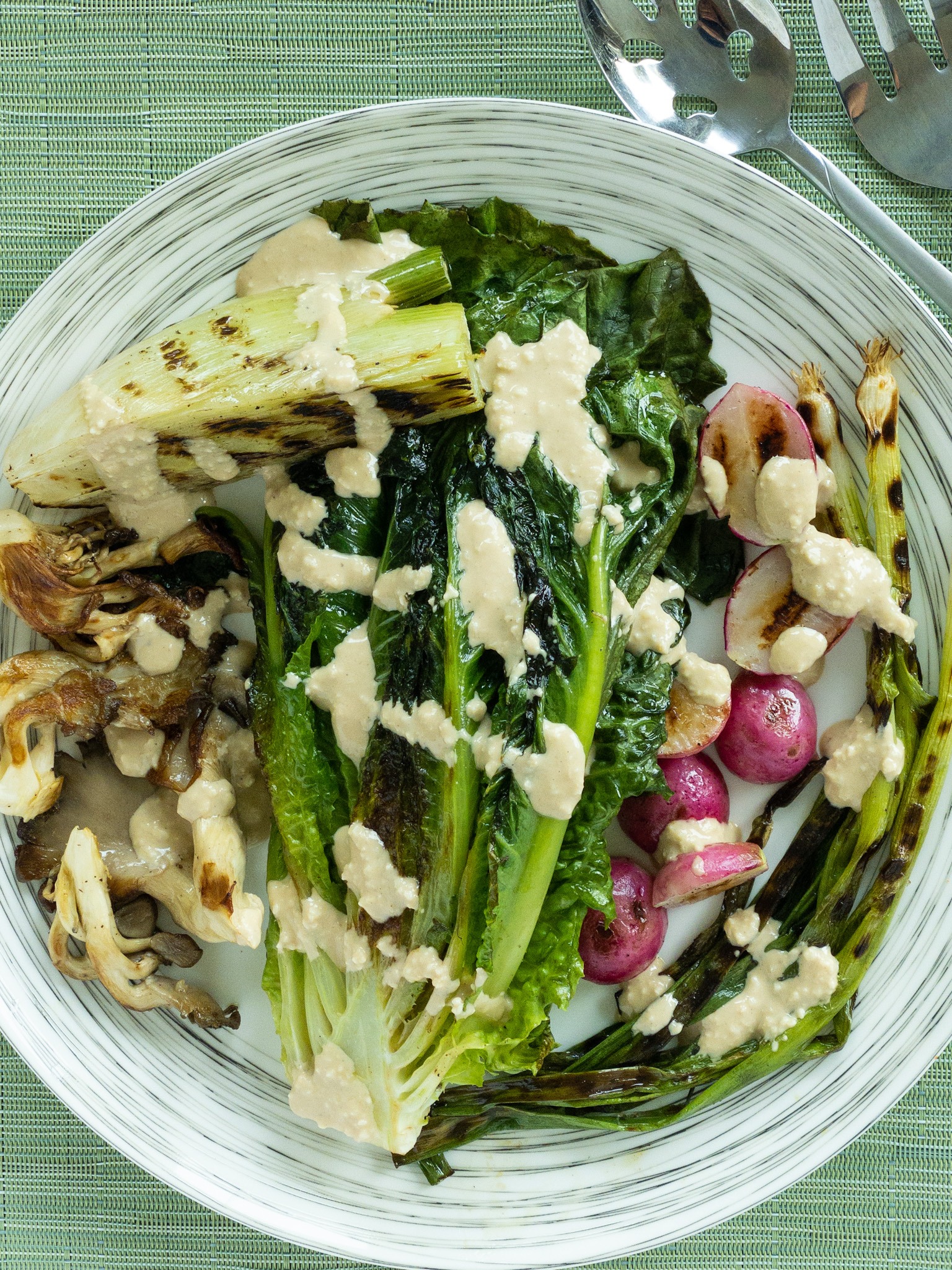 plate of grilled lettuce and vegetables with a Caesar dressing