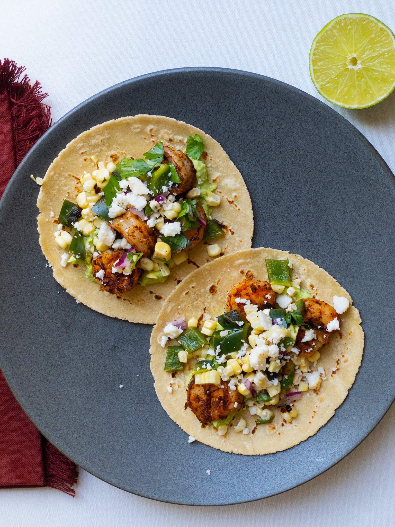 shrimp tacos with corn salsa and avocado crema