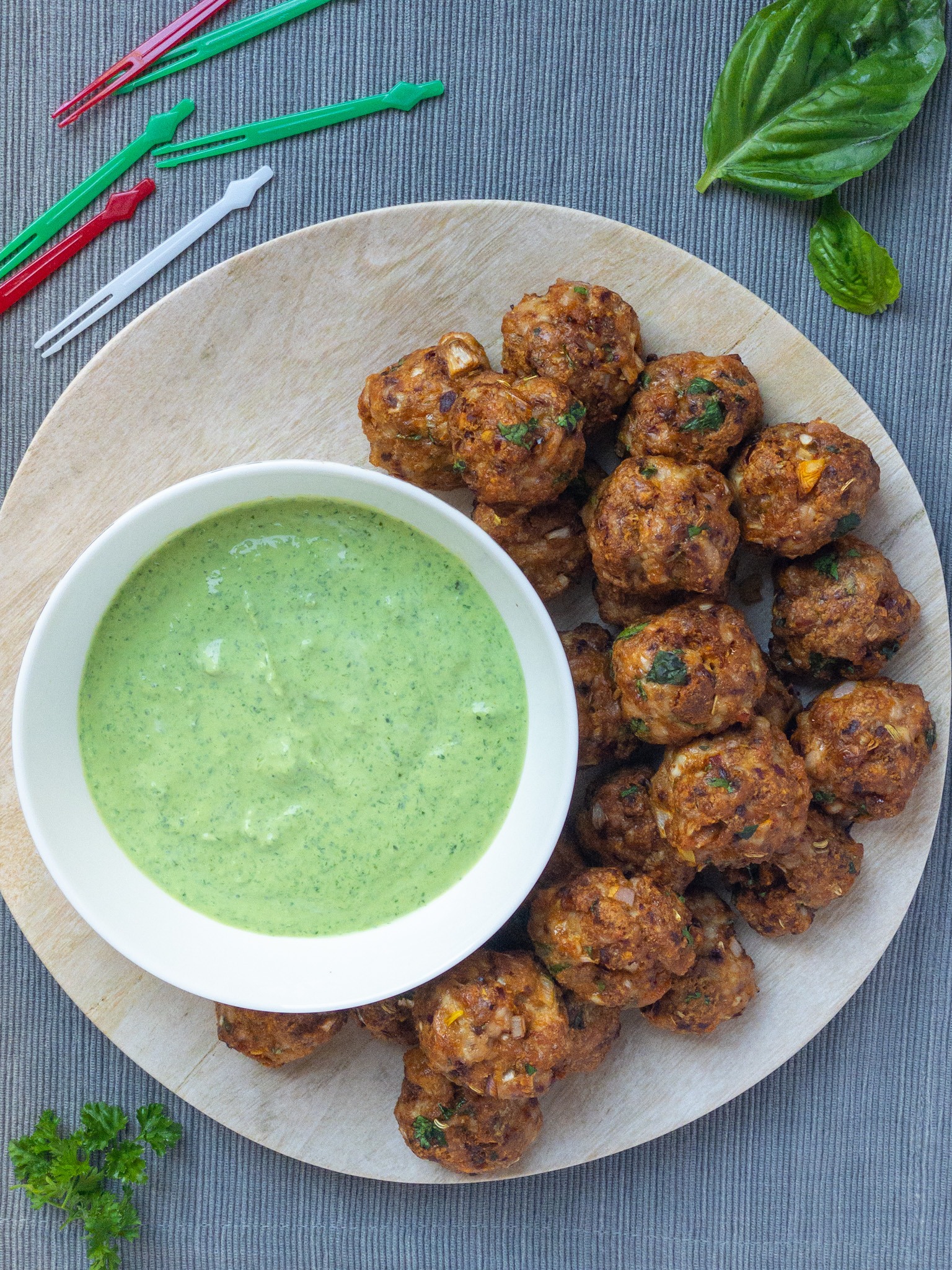 plate of harissa chicken meatballs and bowl of herb dip